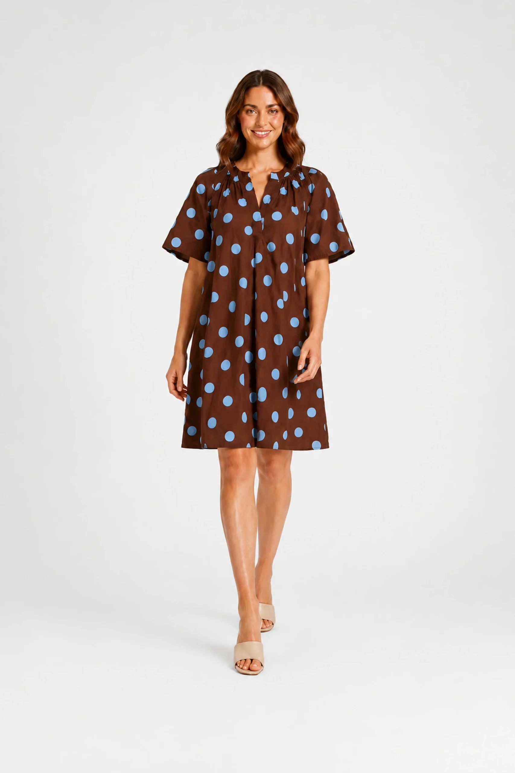 Robe marron à pois bleu ciel portée par un mannequin femme, vue de face